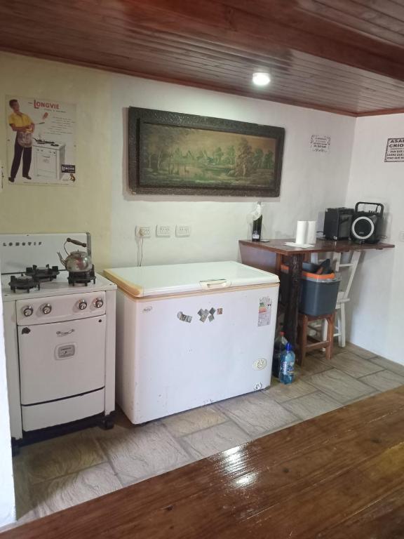 a kitchen with a stove and a table with a picture on the wall at La Soñada in San Miguel del Monte