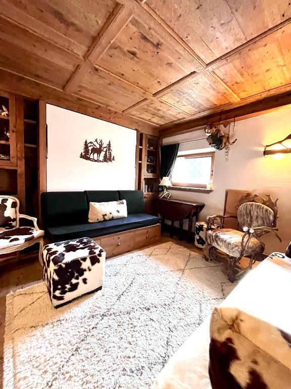 a living room with a couch and a table at Ciasa de Len Cortina in Cortina dʼAmpezzo