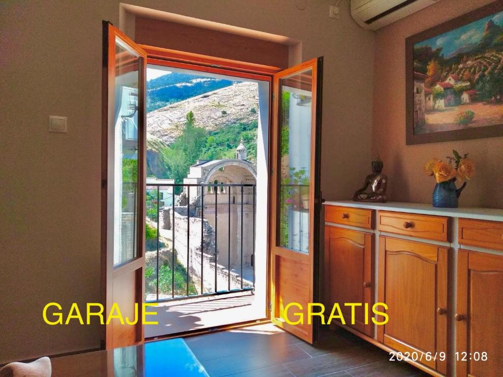 a door to a balcony with a view of a gate at Casa Tio Paco in Cazorla