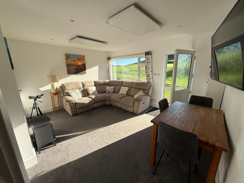 a living room with a couch and a table at Seagulls Rest in Isle of Wight