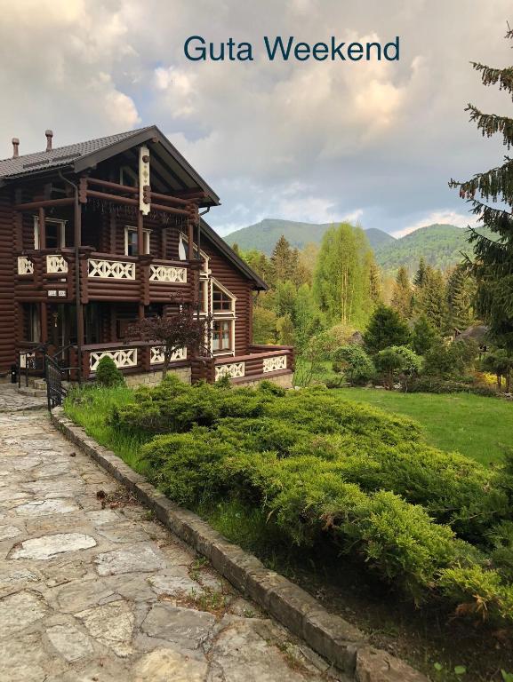 a log cabin with a stone path in front of it at Villa Anna in Guta