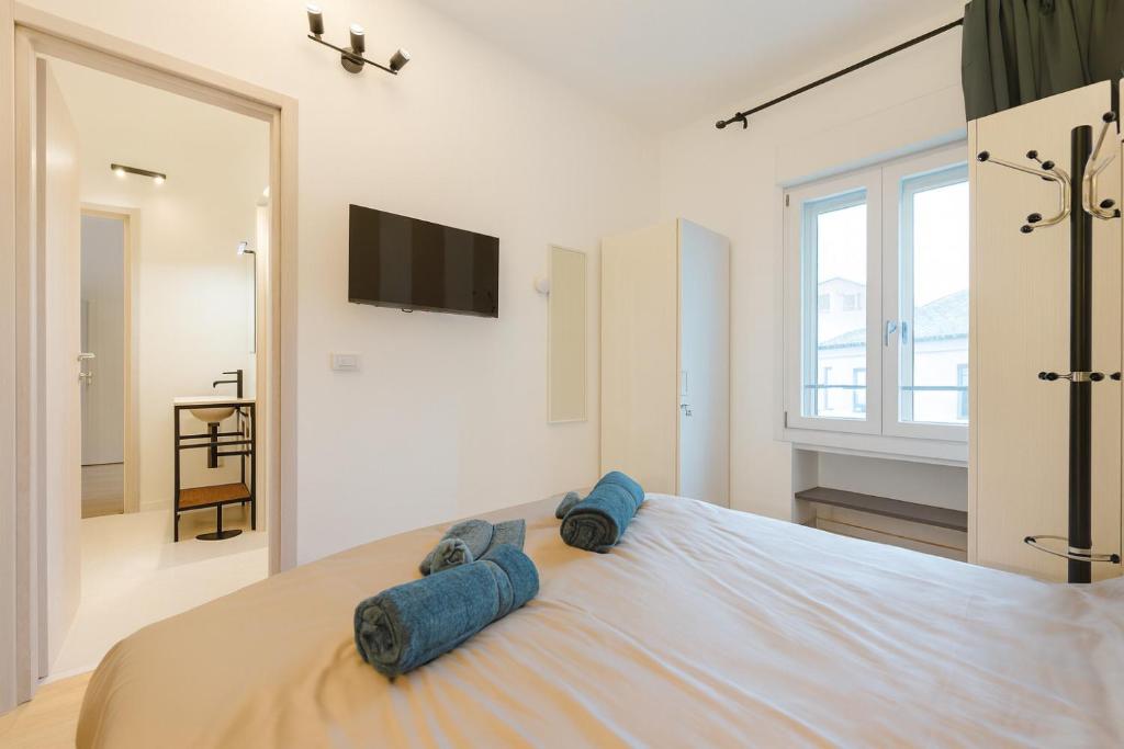 a bedroom with a large bed with blue pillows on it at BonB 127 c7-c8 in Padova