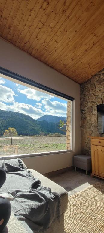 a bedroom with a large window with a view at Casa Rural Las Matillas in Riópar