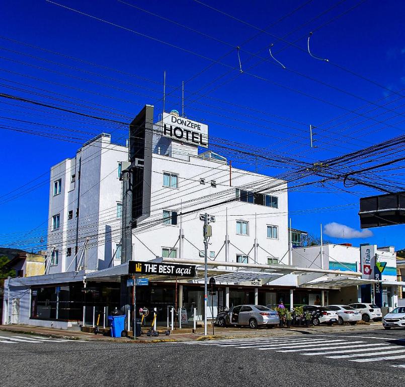 a white building with a sign for a hotel at Hotel Don Zepe in Florianópolis