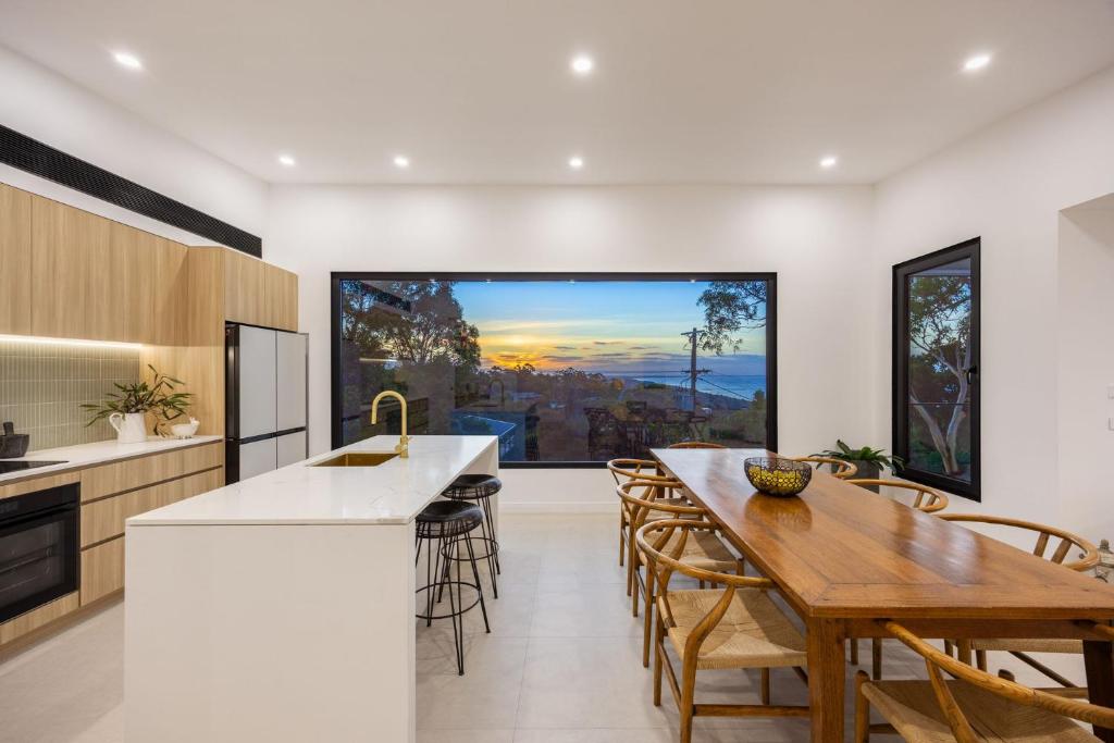 a kitchen with a table and chairs and a large window at Grandview Lookout - McCrae in McCrae