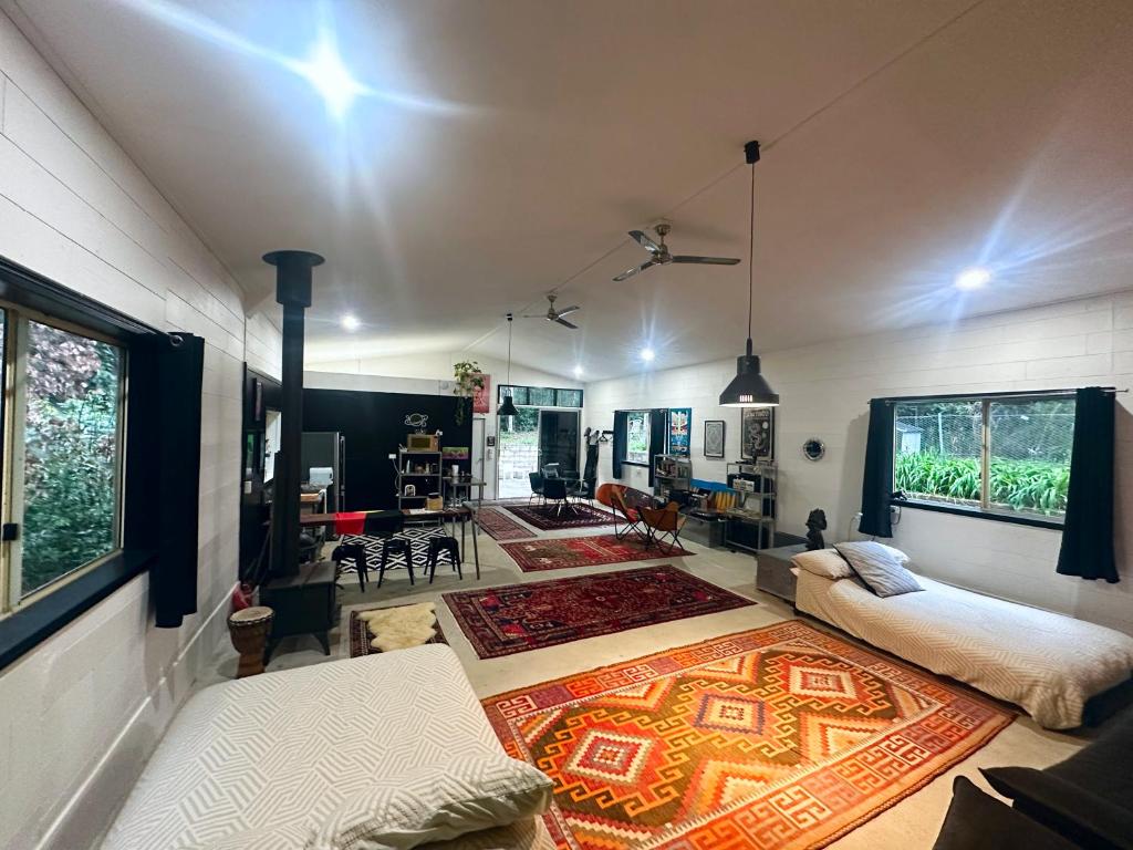 a living room with a couch and a rug at Bellingen Disco Studio in Gleniffer