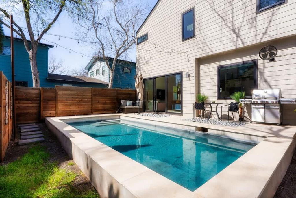 a swimming pool in the backyard of a house at Central Austin Oasis with Pool - Sleeps 9 in Austin