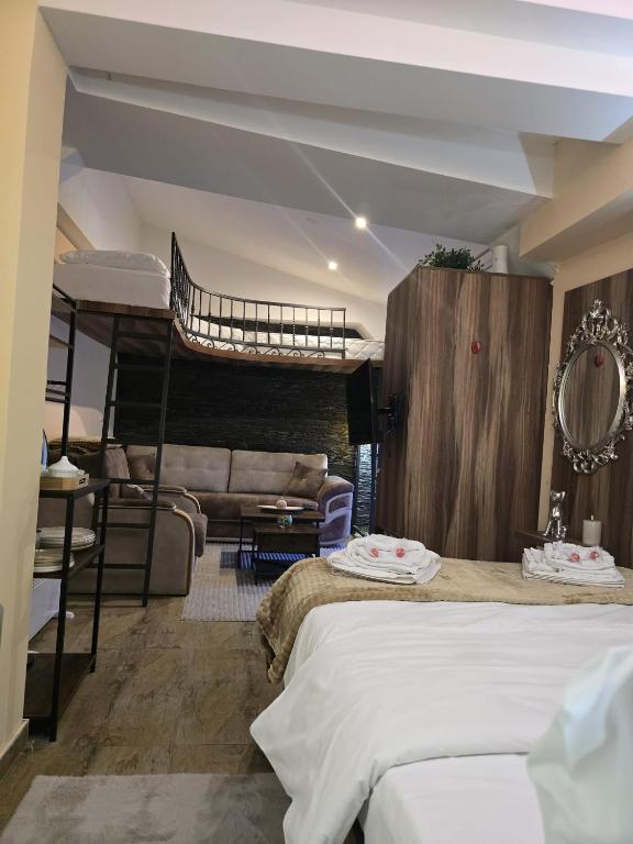 a bedroom with a bunk bed and a couch at Prime NG Mujen lux & spa in Cajetina