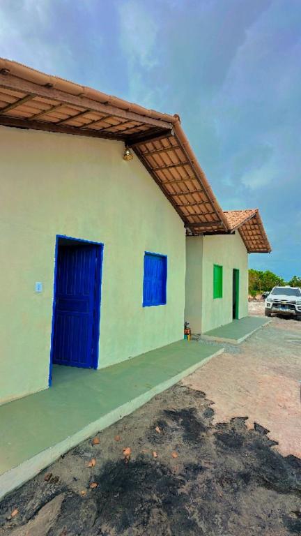 Casa caraiva xandó في بورتو سيغورو: مبنى بأبواب زرقاء في موقف للسيارات