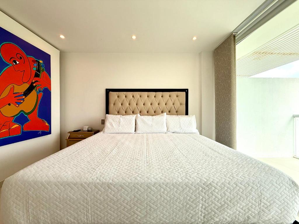 Postel nebo postele na pokoji v ubytování Karibmed Cartagena