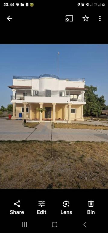 a picture of a large building with chinese writing on it at Rayana's Busura BnB in Brikama