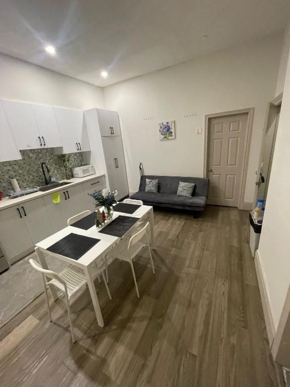 a kitchen and a living room with a table and chairs at Central Downtown New Year Stay- Self Checkin & Free Wifi in Toronto