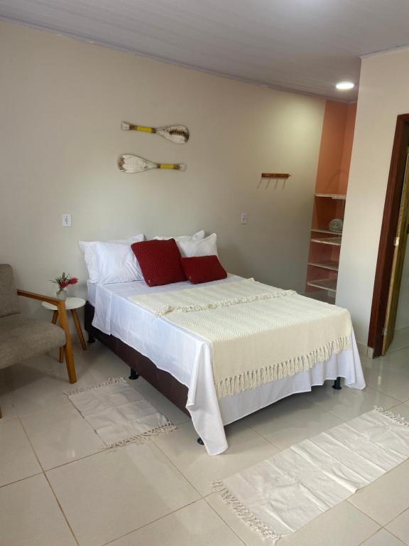 Ένα ή περισσότερα κρεβάτια σε δωμάτιο στο Sabiá & C0 Casa Hotel Suítes