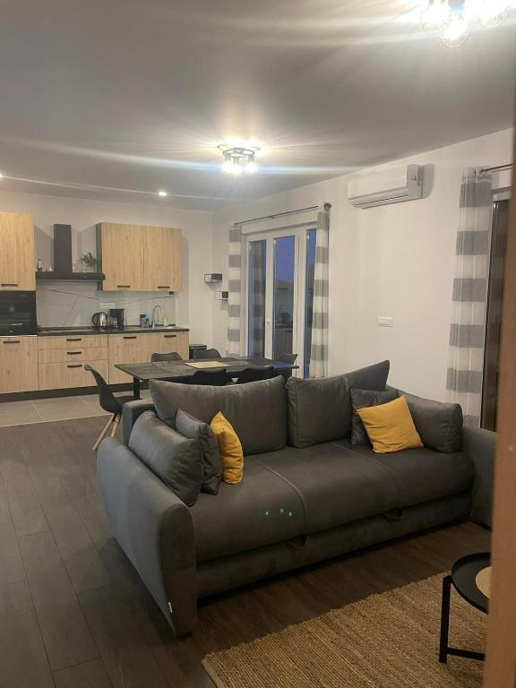 a living room with a couch and a kitchen at Apartmani Ljubica in Duće