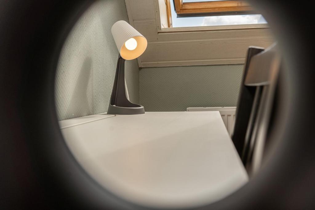 a lamp sitting on a table in a room at Bremen-Weyhe - peaceful - kitchen - wifi in Weyhe