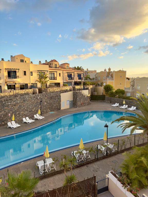 an image of a swimming pool at a resort at Gurugu Beach House in Palm-Mar
