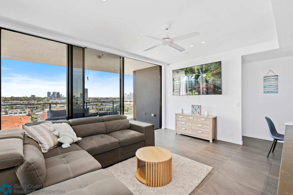 a living room with a couch and some windows at Ocean View 3 Bedroom with Great Facilities in Gold Coast