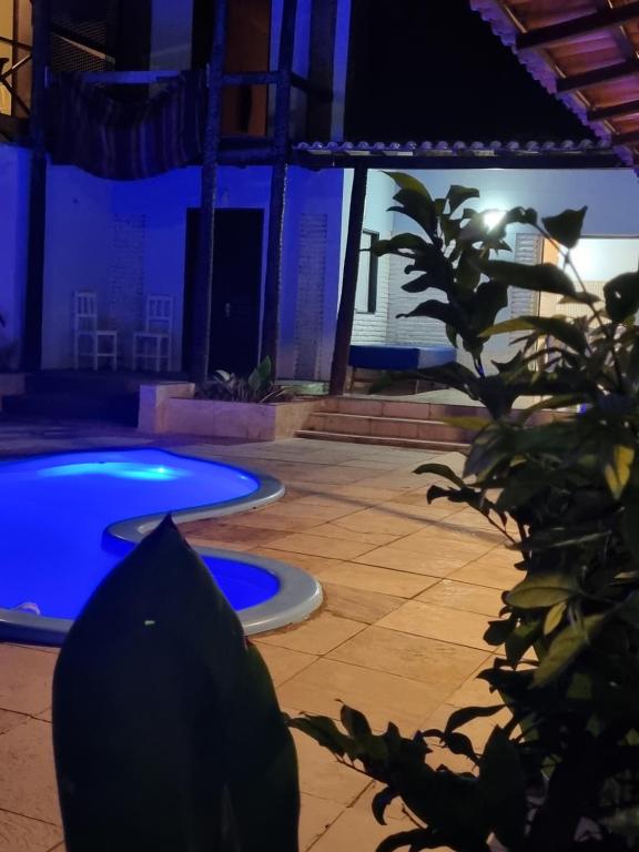 a view of a pool at night with a plant at Casa Petit Canoa Quebrada in Aracati
