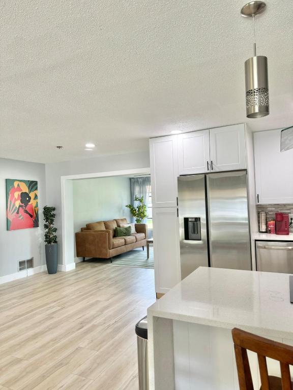 an open kitchen and living room with a couch at Modern cozy Home Palm Coast in Palm Coast