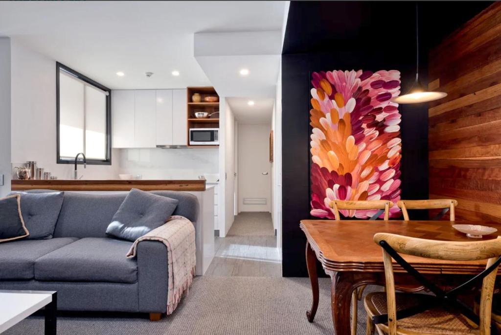 a living room with a couch and a table at Alpine Gloria - Squatters 17 in Thredbo