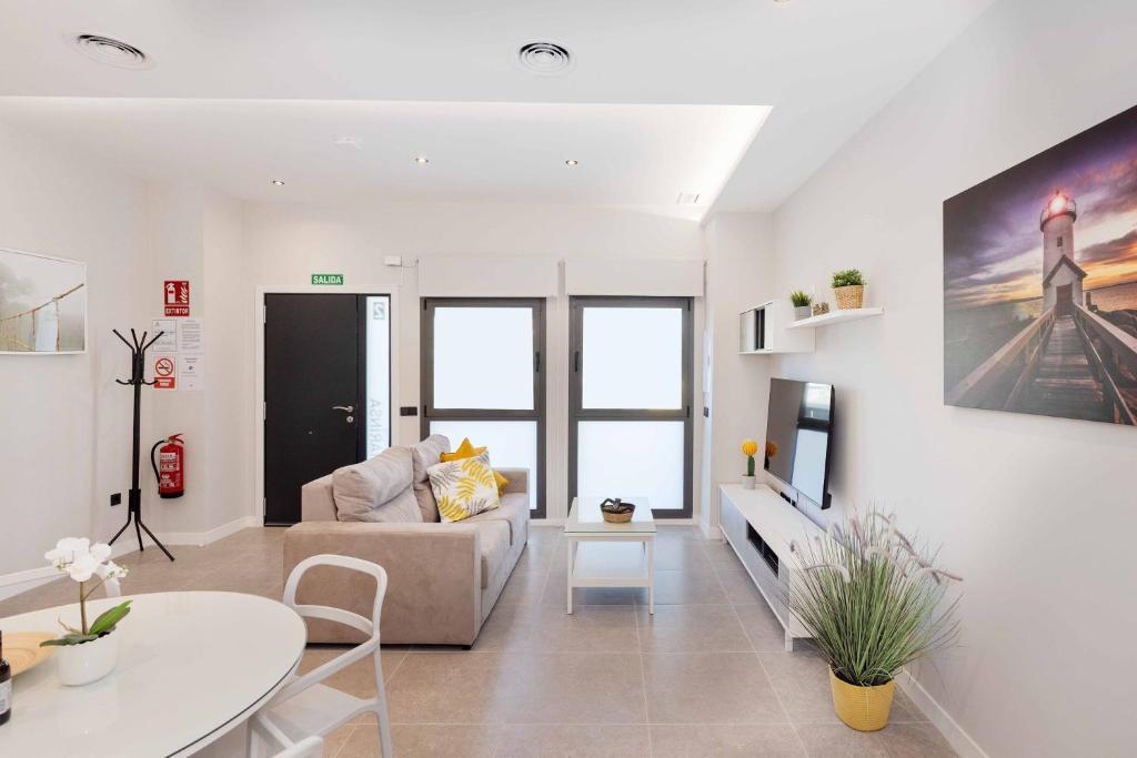 a living room with a couch and a table at Aptos Turísticos Playa Marinsa in Caserío Almayate Bajo