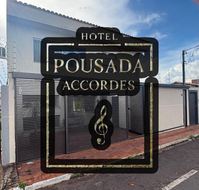 a sign for a hotel pousada aclectoriaarios at Hotel Pousada Accordes in Campo Grande