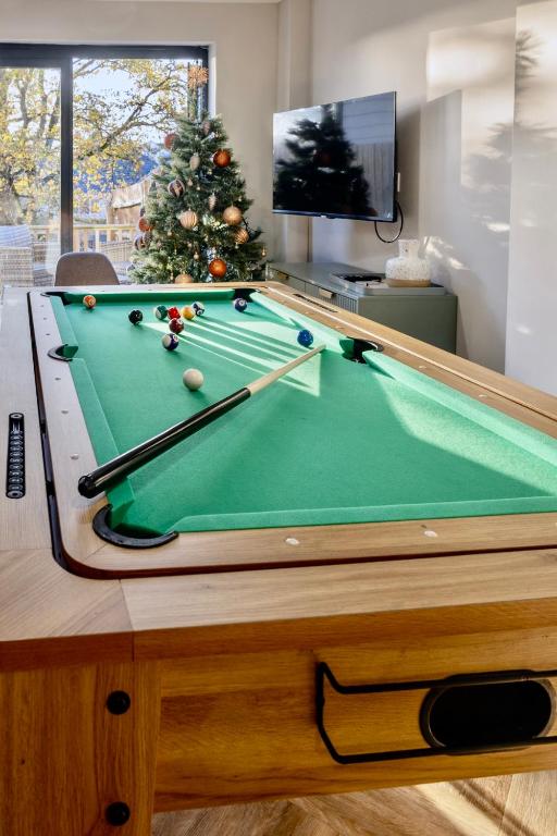 a pool table in a living room with a christmas tree at Luxury Stay, City Walk, Pool Table & Air Hockey, Garden, Parking, Business & Families - Oakview in Colchester