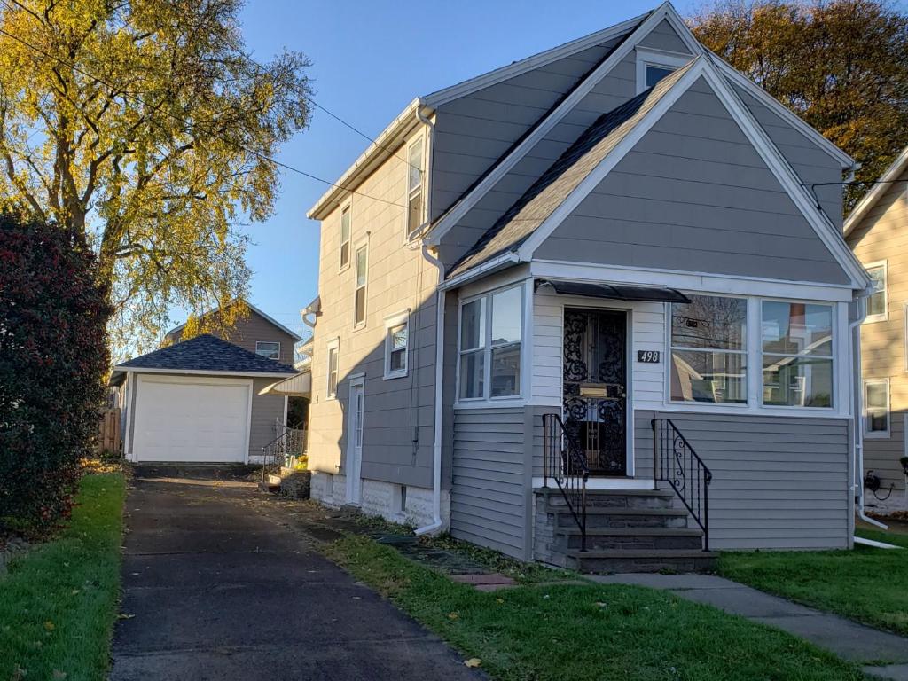a small house with a gray roof and a porch at Grand Central - Pet friendly 3 BR 2 Bath in Johnson City