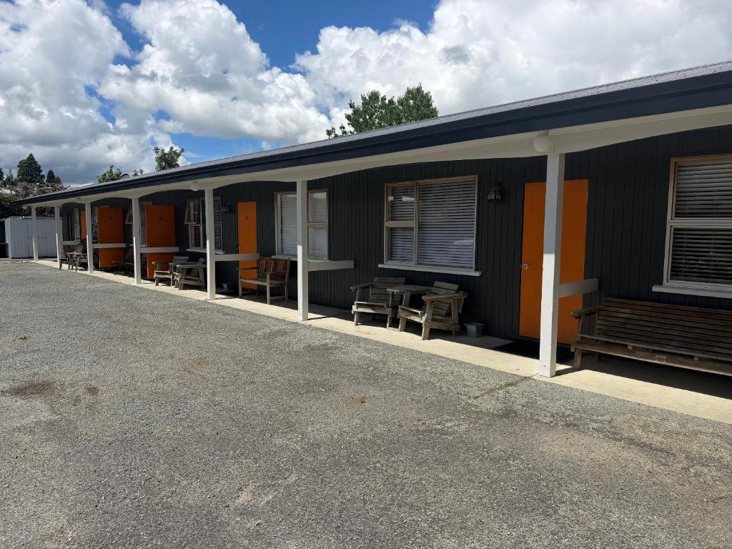 a building with a row of tables and chairs at Lumsden Motel in Lumsden