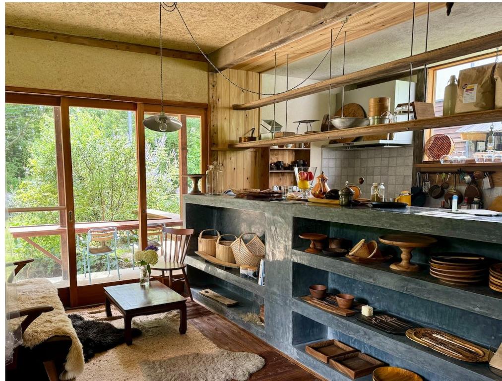 a kitchen with a large blue shelf with pots and pans at Private Forest Cottage for Two, Organic Lifestyle in Bungoono