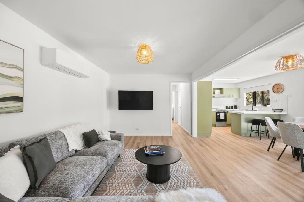 a living room with a couch and a table at Glenkeen Farm and Cabins in Bellbrae
