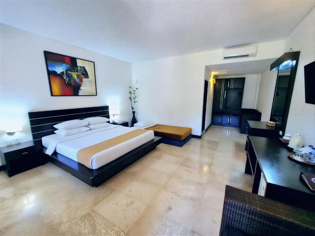 Ένα ή περισσότερα κρεβάτια σε δωμάτιο στο Satriya Cottages