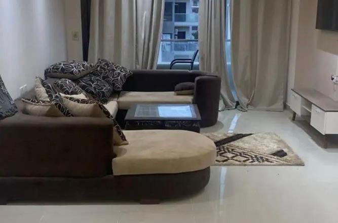 a living room with a couch with a laptop on it at Metallistix wine in Irvine