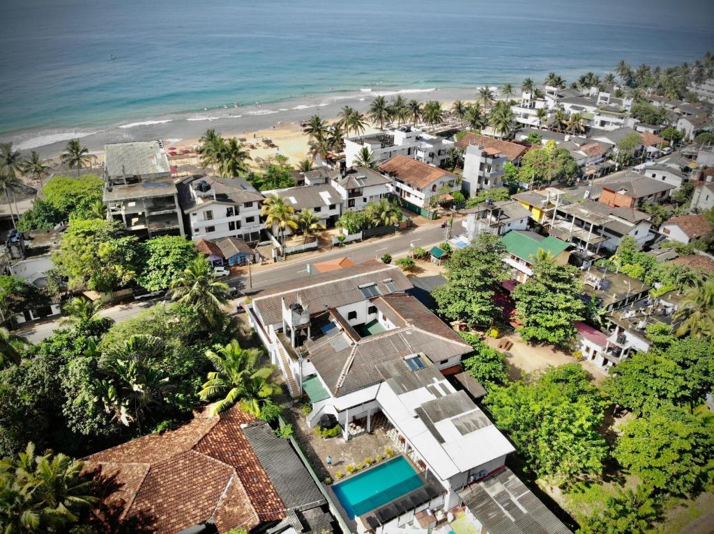 an aerial view of a resort with the beach at Sundowners Guesthouse in Hikkaduwa