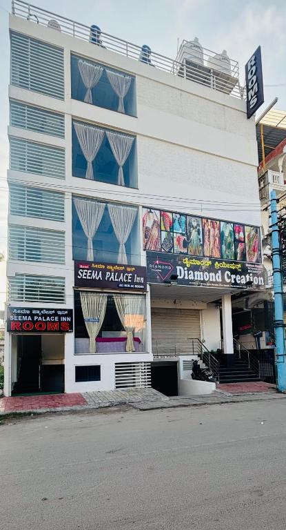 a building with signs on the side of it at Seema Palace Inn 1 km from Railwaystaion in Mysore