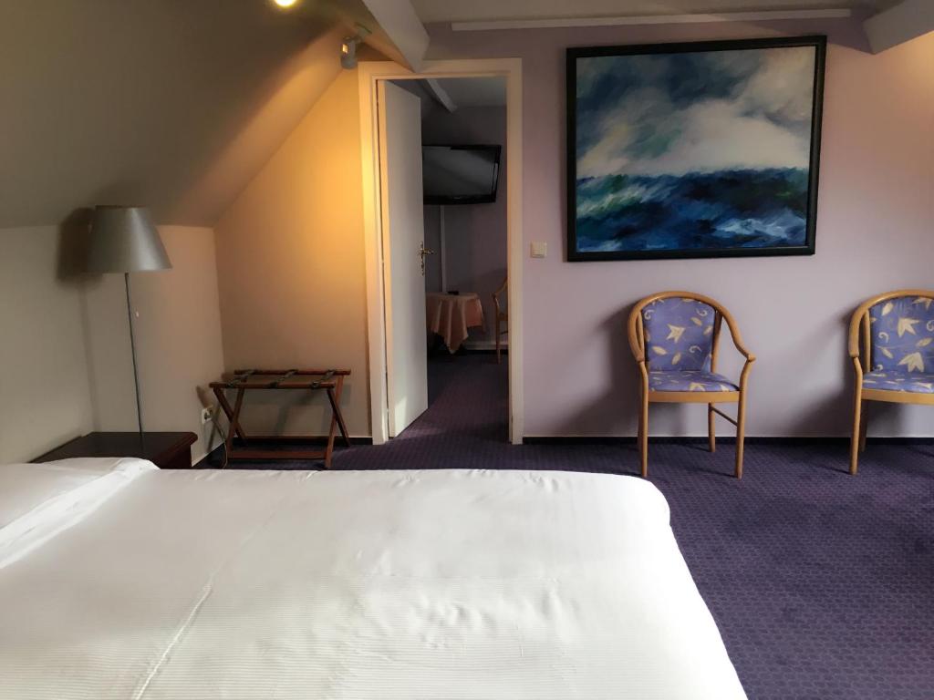 Postel nebo postele na pokoji v ubytování Hotel Claridge