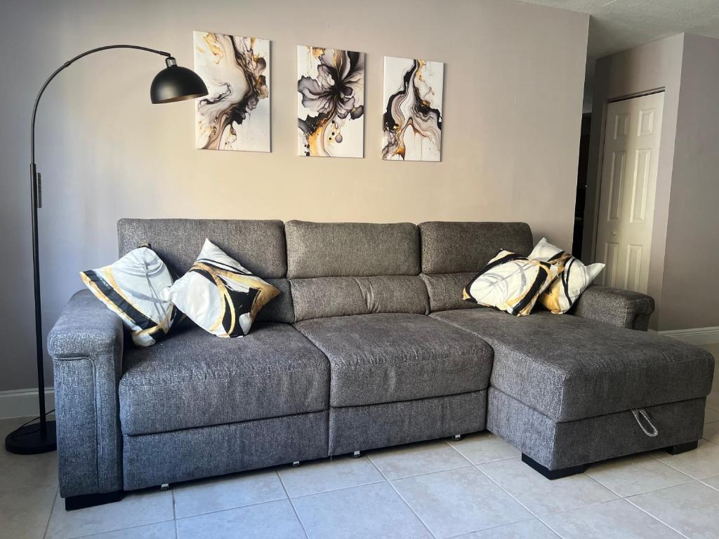 a couch in a living room with pillows on it at Vacation QJR in Cutler Bay