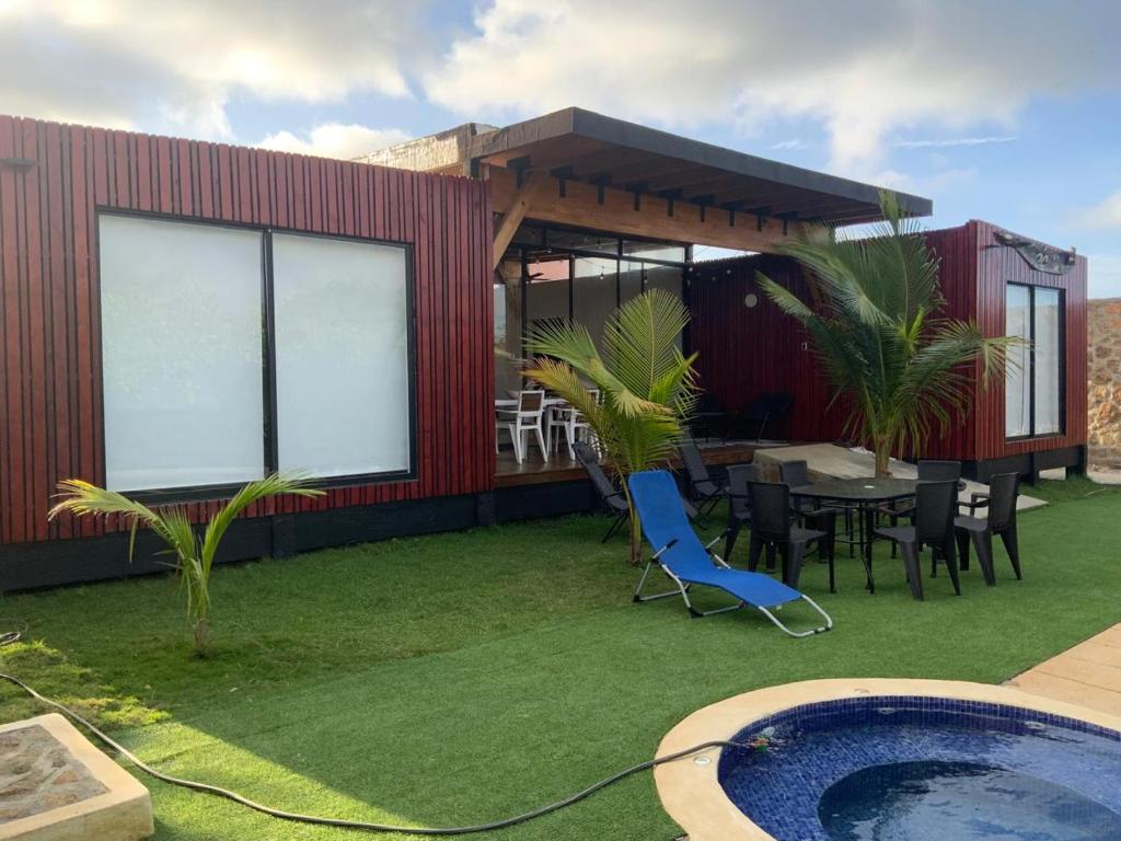 a house with a pool and a table and chairs at Habitacion en Villakite ,Salinas del Rey in Juan de Acosta