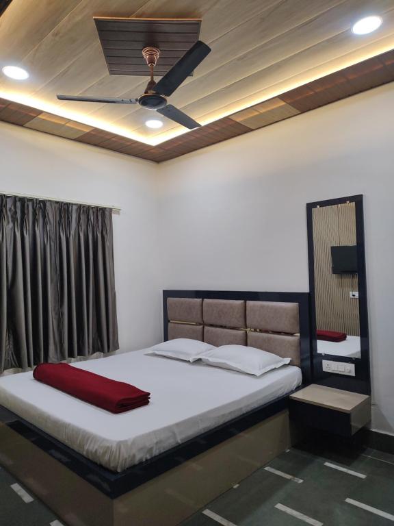 a bedroom with a bed with a ceiling fan at Heritage Kashi in Varanasi