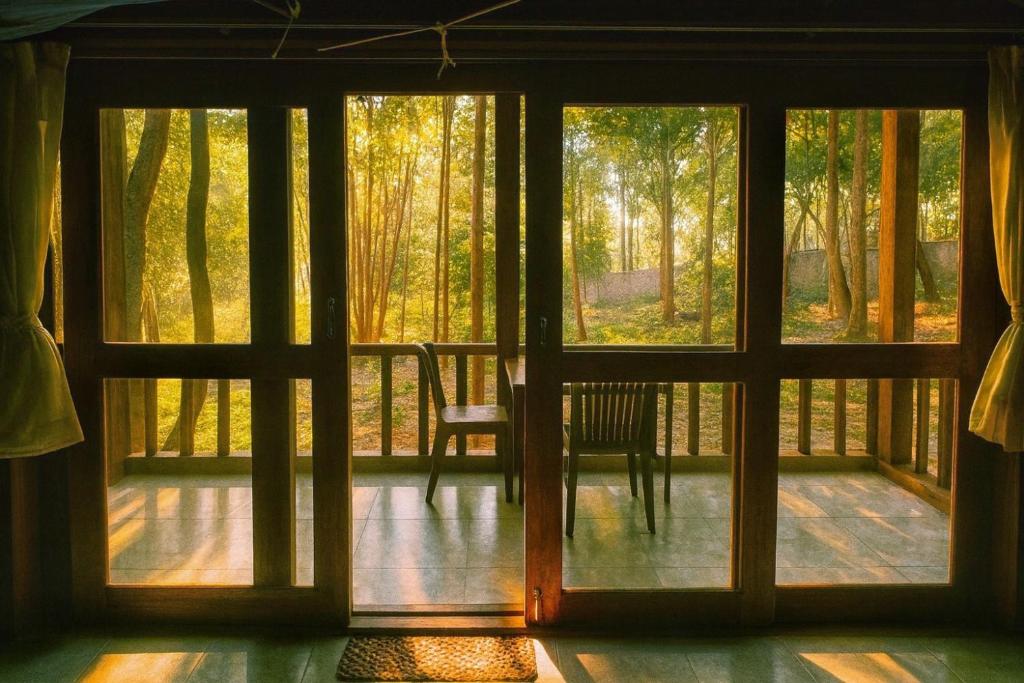 an open door to a porch with a chair outside at Prey Apsara Bungalows in Koh Rong