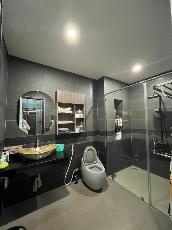a bathroom with a shower and a sink and a toilet at Thiên long homestay in Kinh Dinh