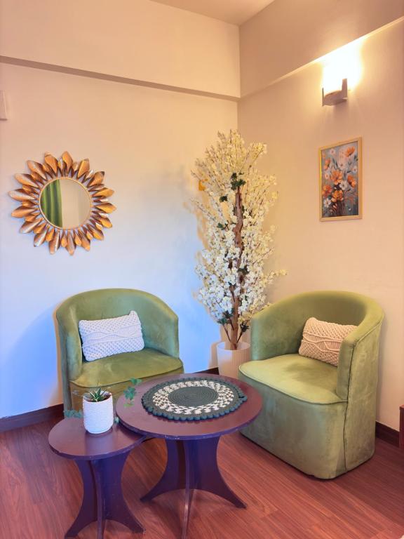 a living room with two chairs and a table at SkyNest in Dehradun