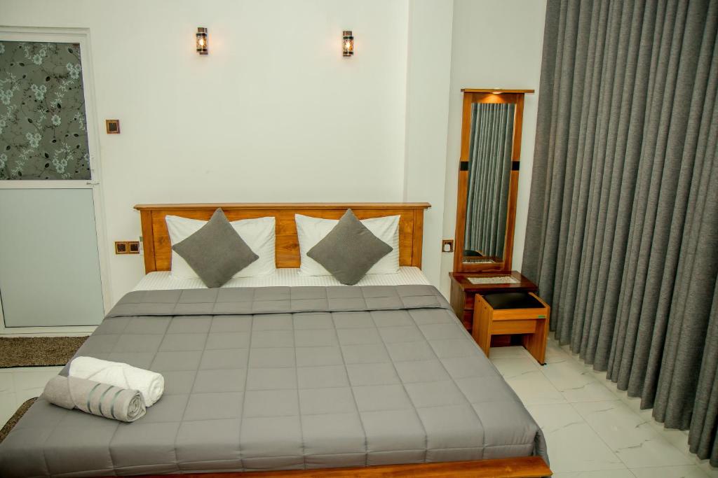 a bedroom with a large bed in a room at Shan Resort in Gintota