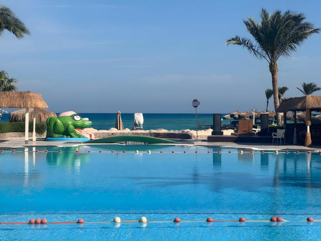 a swimming pool at the beach with a turtle in the background at 4 Bedroom Seaside Hurghada Escape in Hurghada