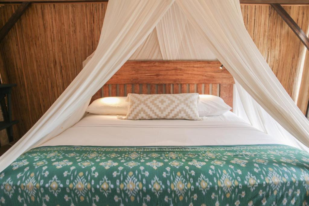 Letto o letti in una camera di MaoMeno Yoga Resort