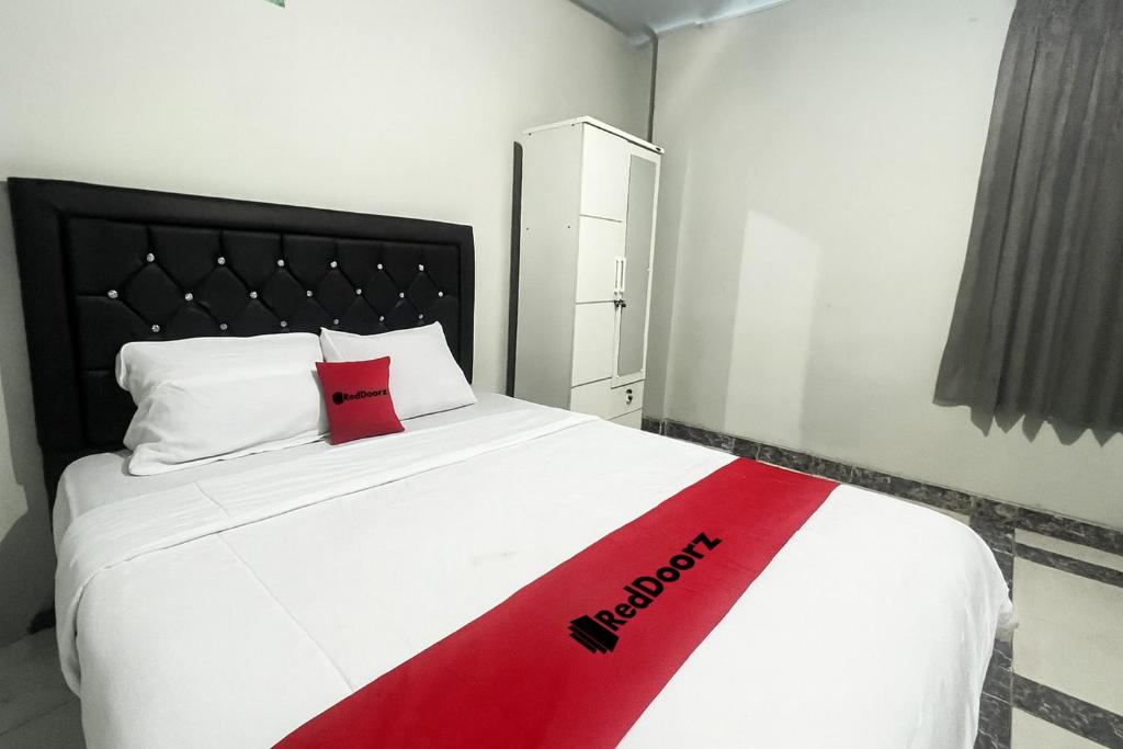 Ένα ή περισσότερα κρεβάτια σε δωμάτιο στο RedDoorz at Mamiric Guest House Syariah