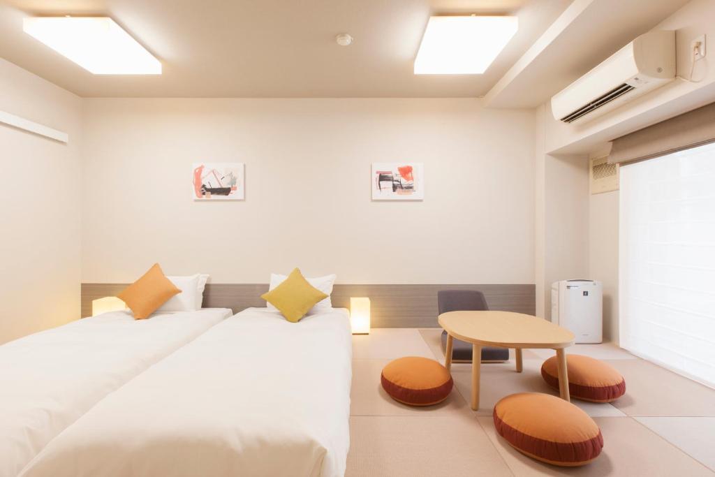 Postel nebo postele na pokoji v ubytování Tokyu Stay Meguro Yutenji