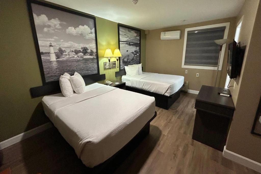 a hotel room with two beds and a television at Super 8 by Wyndham Pembroke in Pembroke