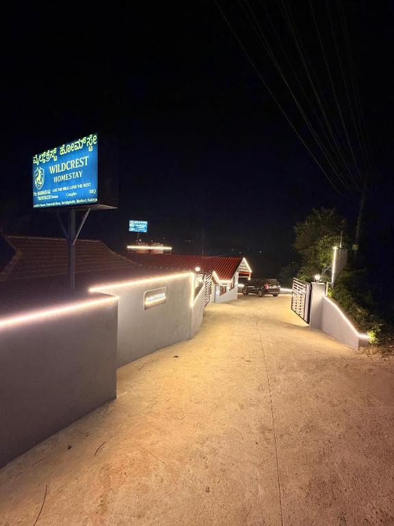 a sign that is on the side of a road at night at Wildcrest Homestay in Madikeri