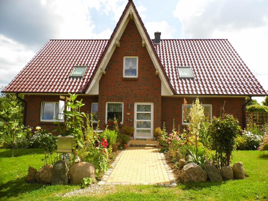 a brick house with a red roof at Haus Nora in Wohlenberg